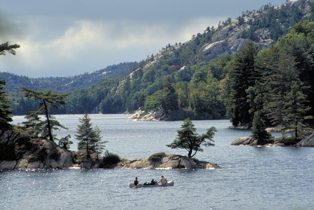 Canoe beneath the white quartzite hills of Killarney Park