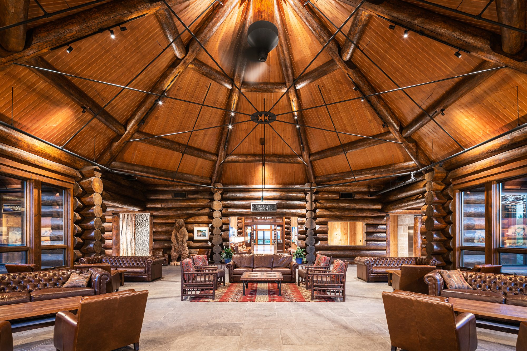The octagonal log rotunda of the Harbour Room, leather chesterfields beneath a radiating timber dome